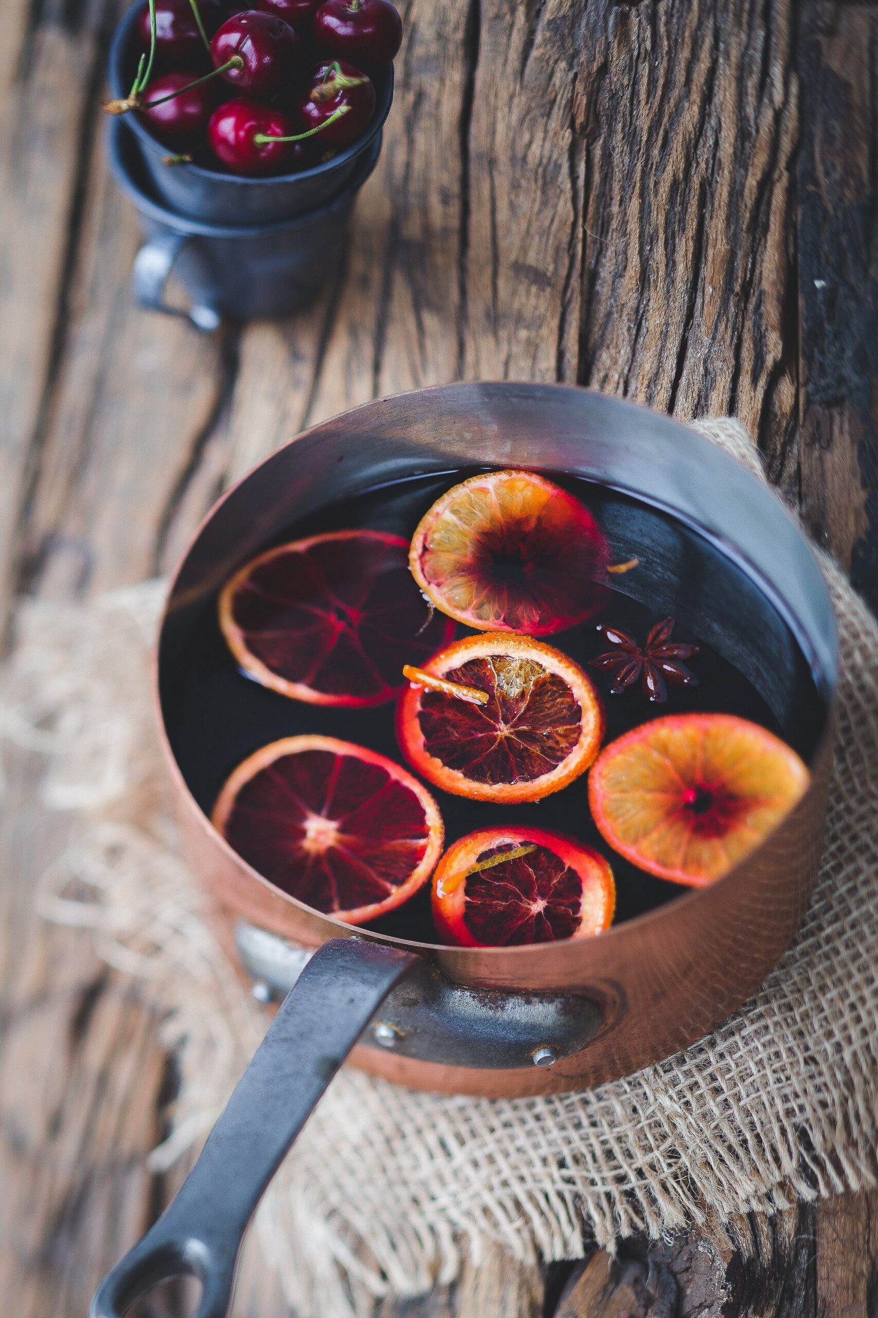 close-up photography of sliced orange fruit on brown cooking pot